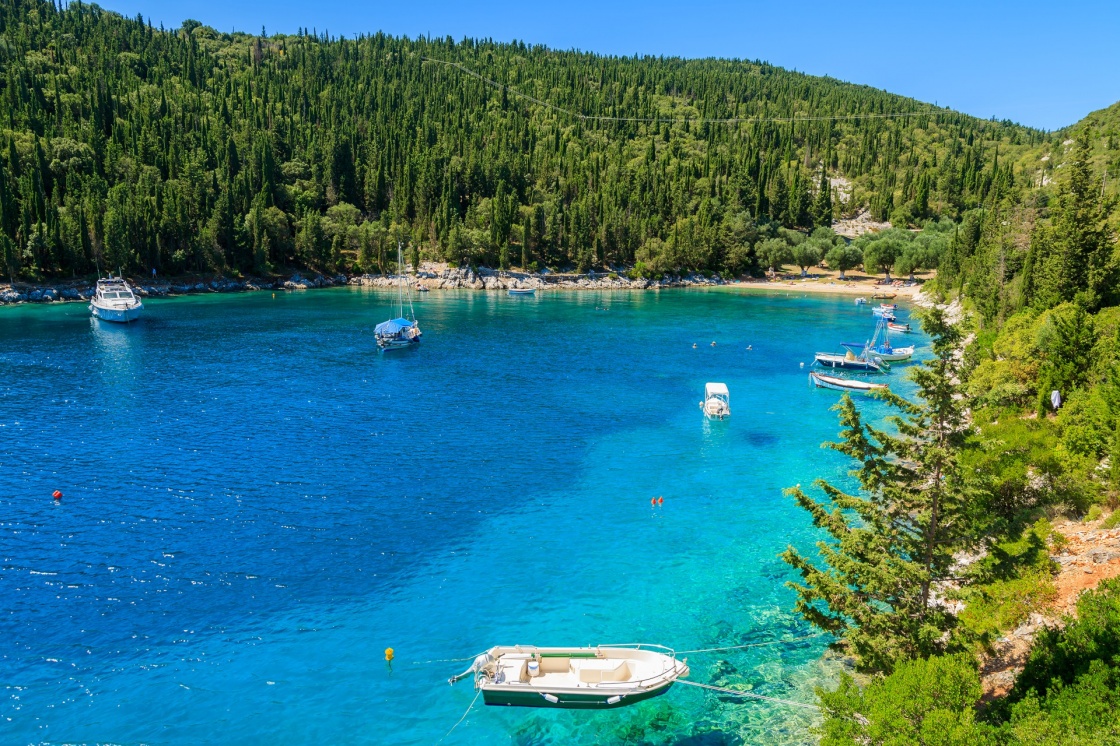 Fishing boats on turquoise sea in bay near Fiskardo village, Kefalonia island, Greece 